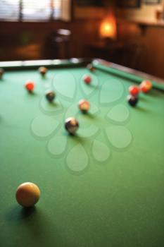 Royalty Free Photo of a Green Billiards Table With Pool Balls Spread Out