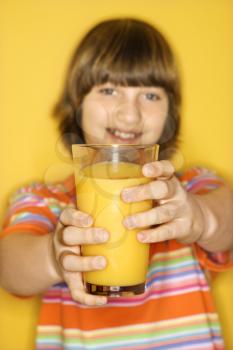 Royalty Free Photo of a Boy Holding a Glass of Orange Juice