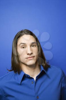 Royalty Free Photo of a Teen Boy Standing Against a Blue Background