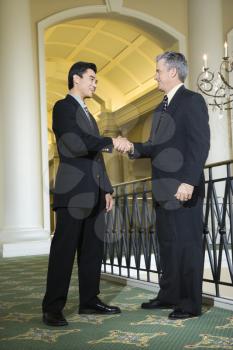 Royalty Free Photo of Businessmen Shaking Hands in a Hotel