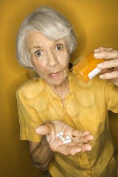 Royalty Free Photo of an Older Woman Holding Pills