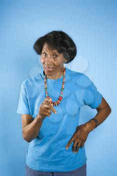 Royalty Free Photo of a African American Female Pointing With Her Hand on Her Hip