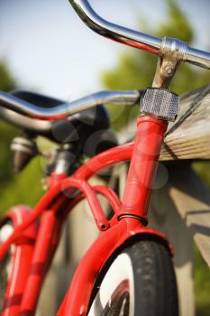 Royalty Free Photo of a Red Bike Leaning Against a Railing 