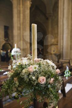 Interior with flower bouquet and candle of Se Cathedral, Lisbon, Portugal.