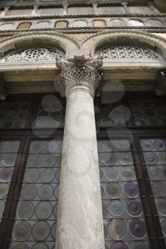 Royalty Free Photo of an Ornate Column and Stained Glass Windows in Venice, Italy