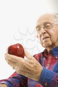 Royalty Free Photo of an Older Man Holding an Apple