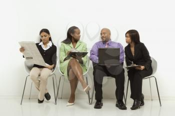 Royalty Free Photo of a Business Group of People Looking at Laptop and Papers