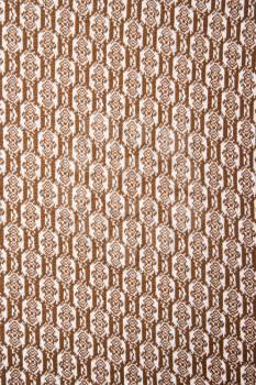Royalty Free Photo of a Woven Vintage Fabric With Brown Repetitive Designs
