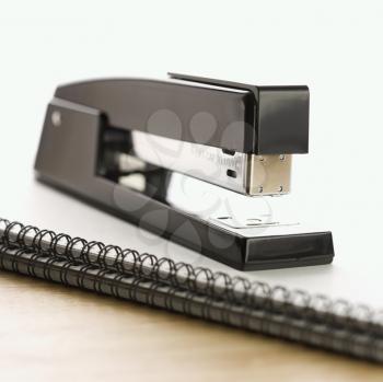 Royalty Free Photo of a Black Stapler on Top of a a Spiral Bound Notebook