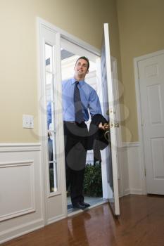 Royalty Free Photo of a Businessman Opening a Door