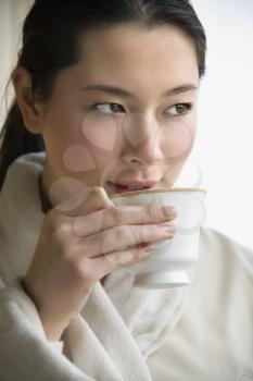 Royalty Free Photo of a Woman in a Bathrobe Drinking Coffee