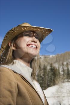 Royalty Free Photo of a Young Woman Wearing a Cowboy Hat Outdoors in Winter