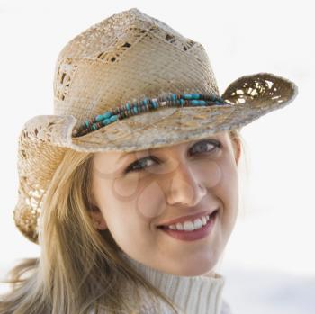 Royalty Free Photo of a Woman Wearing a Cowboy Hat and Smiling
