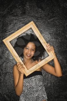 Royalty Free Photo of a Woman Holding a Frame Over Her Face