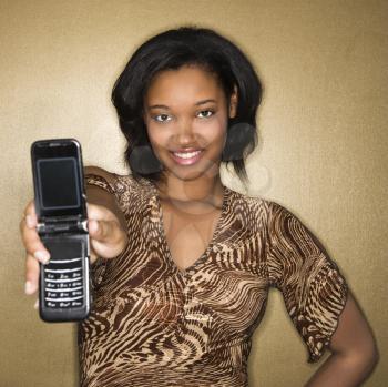Royalty Free Photo of a Young Woman Holding Out a Cellphone