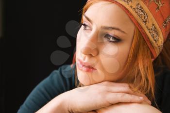 Royalty Free Photo of a Young Redheaded Woman Wearing a Cap Looking Off to the Side