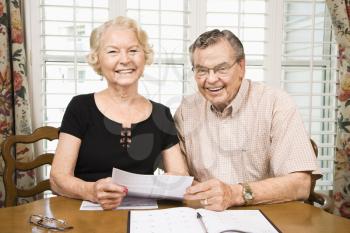Royalty Free Photo of an Older Couple Looking at Their Bills