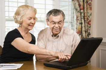Royalty Free Photo of an Older Couple Looking on the Computer