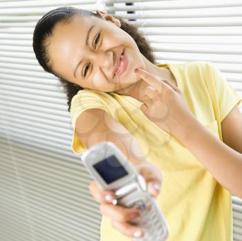 Royalty Free Photo of a Preteen Girl Taking a Picture of Herself With a Cellphone