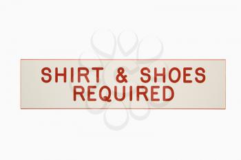 Shirt and shoes required sign.