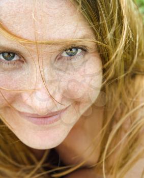 Royalty Free Photo of a Close-up Portrait of an Attractive Redheaded Woman Smiling 