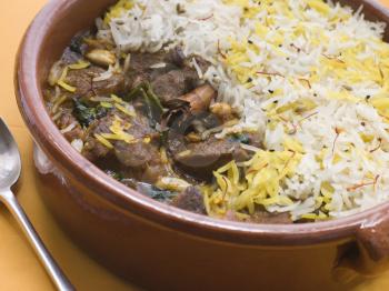 Royalty Free Photo of a Pot of Lamb Biryani With a Spoon