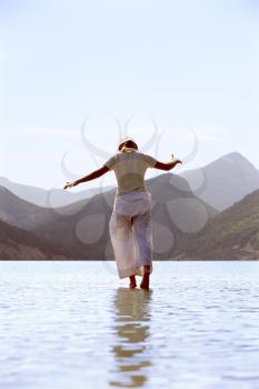 Royalty Free Photo of a Woman Walking in Shallow Water