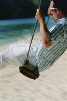 Royalty Free Photo of a Man on a Swing