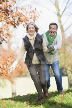 Royalty Free Photo of a Couple Running Around Outside