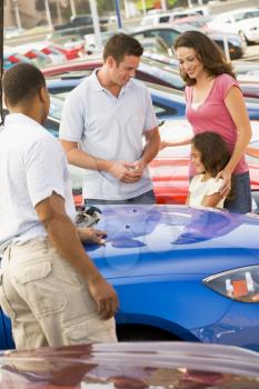 Royalty Free Photo of a Family Shopping for a Car