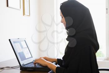 Royalty Free Photo of a Woman in an Office With a Laptop