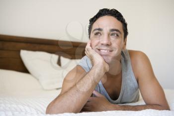 Royalty Free Photo of a Man Lying on His Bed