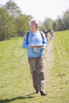 Royalty Free Photo of a Man Walking on a Trail