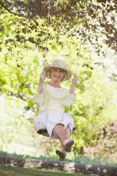 Royalty Free Photo of a Woman on a Swing