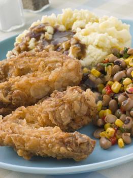 Royalty Free Photo of Southern Fried Chicken Wings with Mash Potato Beans and Gravy