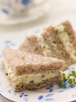 Royalty Free Photo of an Egg and Cress Sandwich on Brown Bread With Afternoon Tea