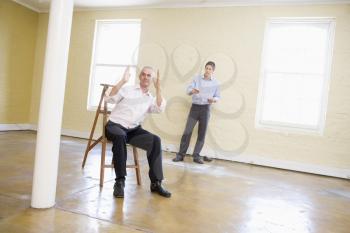 Royalty Free Photo of Two Men in an Empty Rom