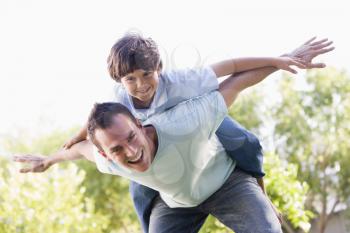 Royalty Free Photo of a Father Giving His Son a Plane Ride