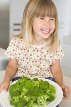 Royalty Free Photo of a Girl With a Plate of Broccoli
