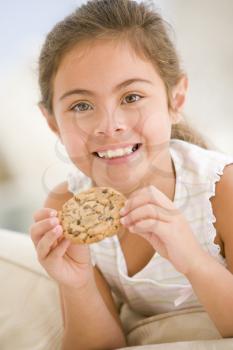 Royalty Free Photo of a Girl Eating a Cookie