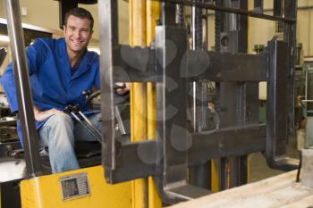 Royalty Free Photo of a Man in a Forklift