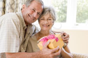 Royalty Free Photo of a Man Giving His Wife a Gift