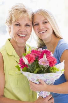 Royalty Free Photo of a Grandmother and Granddaughter With Flowers