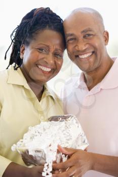 Royalty Free Photo of a Man Giving His Wife a Gift