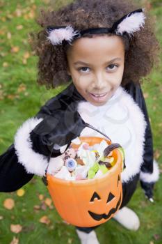 Royalty Free Photo of a Girl in a Cat Costume With Candy