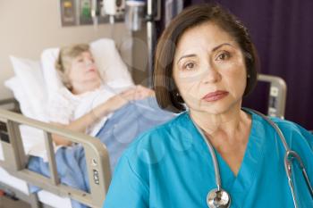 Royalty Free Photo of a Doctor in a Patient's Room Looking Worried