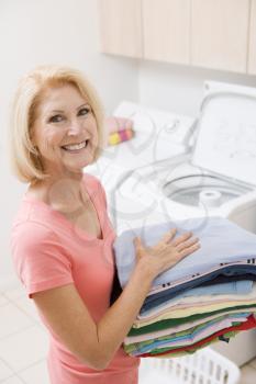 Royalty Free Photo of a Woman With Folded Laundry