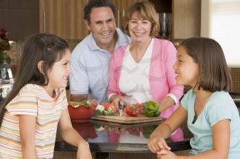 Royalty Free Photo of a Family Preparing a Meal