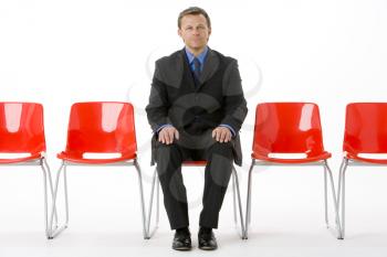 Royalty Free Photo of a Man Sitting on a Chair