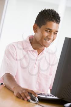 Royalty Free Photo of a Teenage Boy at the Computer